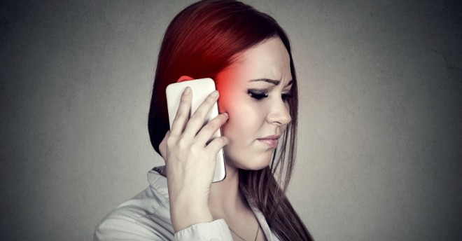 Upset sad woman talking on mobile phone. Cellular mobile radiation